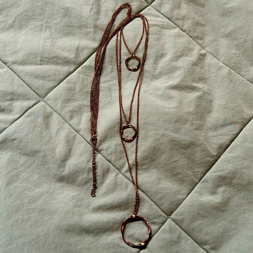 Gold tone necklace three strands with rings